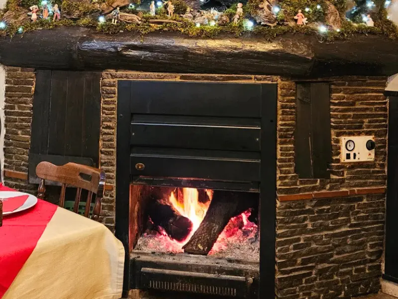 Lit fireplace during Christmas lunch at farmhouse